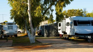 Camping with RVs and caravans in a scenic outdoor setting.