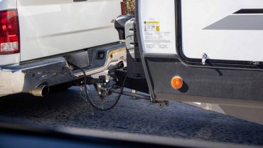 Trailer hitch connection on RV for travel adventures.