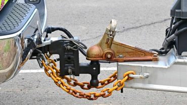 Trailer hitch with safety chains on a caravan or RV.