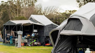 Outdoor camping tents with gear and bicycles.