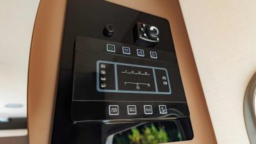 Smart home control panel with touchscreen for RV automation and monitoring.