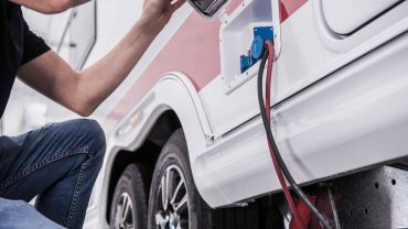 EV charging port with cable plugged in to an electric vehicle.