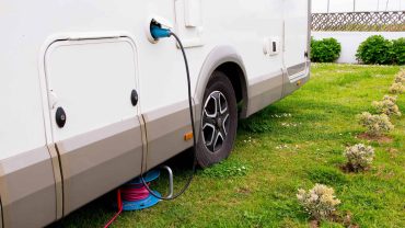 Solar-powered motorhome with external electrical hookup for off-grid camping.