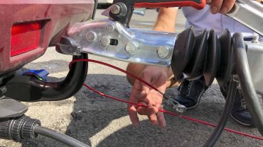 Vehicle hitch with trailer connection and safety cable.