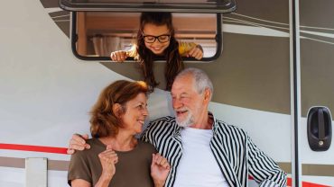 Family enjoying travel in a campervan, capturing joyful moments on holiday.